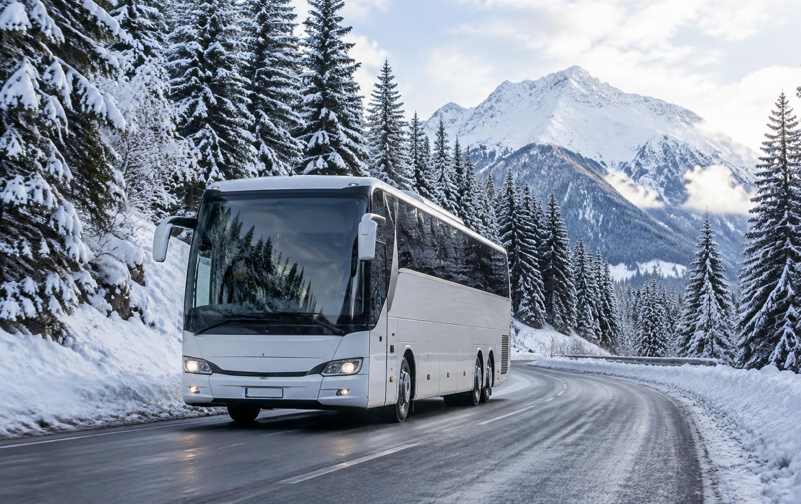 A touring coach on a snowy alpine road